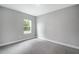 Carpeted bedroom with a window, neutral walls, and a blank canvas for personalization at 4780 Sw 129Th Pl, Ocala, FL 34473