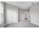 Spacious bedroom featuring gray carpet, neutral paint, and a walk-in closet at 4780 Sw 129Th Pl, Ocala, FL 34473