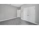 Bedroom with closet and ensuite access, featuring neutral carpet and light grey walls at 4780 Sw 129Th Pl, Ocala, FL 34473