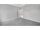 Empty bedroom featuring carpet, a neutral color palette, and tray ceiling at 4780 Sw 129Th Pl, Ocala, FL 34473