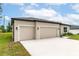 This home features a two-car garage, neutral paint, and a well-maintained lawn at 4780 Sw 129Th Pl, Ocala, FL 34473