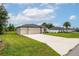 A single-story home with a manicured lawn, driveway, and a two-car garage with neutral paint at 4780 Sw 129Th Pl, Ocala, FL 34473