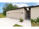 This single-story home has a two-car garage, neutral paint, and manicured lawn at 4780 Sw 129Th Pl, Ocala, FL 34473