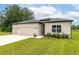 This single-story home has a two-car garage, neutral paint, and manicured lawn at 4780 Sw 129Th Pl, Ocala, FL 34473