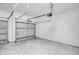 One car garage with white walls, concrete floors, and a white garage door at 4780 Sw 129Th Pl, Ocala, FL 34473