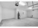 White walled garage with concrete floors, water heater and modern door opening hardware at 4780 Sw 129Th Pl, Ocala, FL 34473
