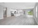 A stylish open-concept kitchen features white cabinets, a center island, and stainless steel appliances at 4780 Sw 129Th Pl, Ocala, FL 34473