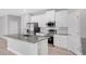 Modern kitchen island featuring gray countertop, white cabinets, stainless appliances, and recessed lighting at 4780 Sw 129Th Pl, Ocala, FL 34473