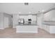 Bright kitchen featuring white cabinets, stainless steel appliances, and a center island with a sink at 4780 Sw 129Th Pl, Ocala, FL 34473
