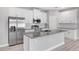 Close-up of a modern kitchen island with granite countertop, stainless steel sink, and white cabinetry at 4780 Sw 129Th Pl, Ocala, FL 34473