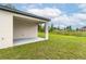 Open patio with white pillars and manicured lawn at 4780 Sw 129Th Pl, Ocala, FL 34473
