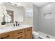 Elegant bathroom features a wooden vanity, black hardware, and a stylish walk-in shower at 4858 Brenda Dr, Orlando, FL 32812