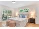 Light-filled bedroom with sliding glass doors to the patio, light hardwood floors and light blue decorative pillows at 4858 Brenda Dr, Orlando, FL 32812