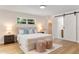 Bright bedroom features light hardwood floors, neutral walls, and a barn-style door to an ensuite bathroom at 4858 Brenda Dr, Orlando, FL 32812