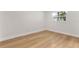 Cozy bedroom featuring light hardwood floors, neutral walls, and bright natural light at 4858 Brenda Dr, Orlando, FL 32812