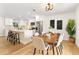 Charming dining area with a wooden table, seamlessly connects to the modern, open-concept kitchen space at 4858 Brenda Dr, Orlando, FL 32812