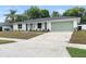 Beautiful one-story home featuring a well-maintained lawn and charming curb appeal, including a green garage door at 4858 Brenda Dr, Orlando, FL 32812
