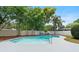 Enjoy this backyard pool area surrounded by a privacy fence and lush landscaping at 4858 Brenda Dr, Orlando, FL 32812