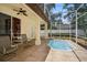 Enclosed patio with spa, seating area, and ceiling fans for relaxing outdoor living at 489 Penny Ln, Maitland, FL 32751