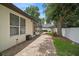 Well-maintained yard features mature trees, a paver patio, and enclosed spa at 489 Penny Ln, Maitland, FL 32751