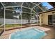 Lovely backyard featuring a screened-in patio, a spa, and manicured lawn at 489 Penny Ln, Maitland, FL 32751