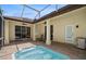 A screened-in patio with a spa, lights, and fan offers a relaxing outdoor space at 489 Penny Ln, Maitland, FL 32751