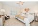 Relaxing bedroom featuring shutters, a ceiling fan, and tiled flooring at 489 Penny Ln, Maitland, FL 32751