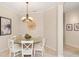 Cozy dining room with decorative lighting and seating for six at 489 Penny Ln, Maitland, FL 32751