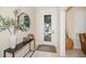 Welcoming foyer with stylish decor, a decorative mirror and a view of the front yard at 489 Penny Ln, Maitland, FL 32751