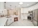 Bright kitchen featuring white cabinets, stainless steel appliances, and tile flooring at 489 Penny Ln, Maitland, FL 32751