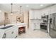 Bright kitchen with stainless steel appliances, granite countertops, and white cabinetry at 489 Penny Ln, Maitland, FL 32751