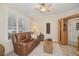 Cozy living room with comfortable leather seating, natural lighting, and tiled floors at 489 Penny Ln, Maitland, FL 32751