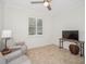 Inviting sitting room with neutral paint, tile floors, and a ceiling fan at 489 Penny Ln, Maitland, FL 32751
