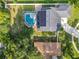 Aerial view of home with screened in pool and long driveway at 4942 Eden View Ct, Orlando, FL 32810
