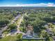Wide angle aerial view of house in a tree filled neighborhood with many houses at 4942 Eden View Ct, Orlando, FL 32810