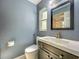 A well-lit bathroom showcasing a sleek vanity with a modern faucet, a toilet, and a large framed mirror at 4942 Eden View Ct, Orlando, FL 32810