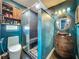 Unique bathroom featuring a rustic vanity, custom walk-in shower and turquoise walls at 4942 Eden View Ct, Orlando, FL 32810