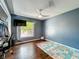 A comfortable bedroom with a play mat, a large window and a modern ceiling fan at 4942 Eden View Ct, Orlando, FL 32810