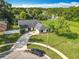 Aerial view of single story home with long driveway and plenty of yard space at 4942 Eden View Ct, Orlando, FL 32810