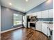 Well-lit kitchen showcasing stainless steel appliances, hardwood floors, and white cabinets at 4942 Eden View Ct, Orlando, FL 32810