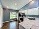 Kitchen with stainless steel appliances, hardwood floors, white cabinets and eat-in nook at 4942 Eden View Ct, Orlando, FL 32810