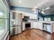 Bright kitchen boasts stainless steel appliances, a large window, and white cabinets at 4942 Eden View Ct, Orlando, FL 32810