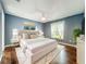 A beautifully staged bedroom featuring a large bed with decorative pillows, modern lighting, and stylish wall art at 4942 Eden View Ct, Orlando, FL 32810