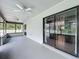 Spacious screened patio with multiple ceiling fans and sliding glass doors overlooking the backyard at 4942 Eden View Ct, Orlando, FL 32810