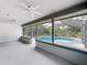Large screened patio with two ceiling fans overlooking a pristine pool and backyard at 4942 Eden View Ct, Orlando, FL 32810