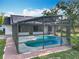 A screened in pool with brick trim along the outside and a partial view of the house at 4942 Eden View Ct, Orlando, FL 32810