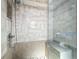 Modern shower featuring neutral tile, a sleek shower head and a built-in bench at 4942 Eden View Ct, Orlando, FL 32810