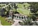 A captivating aerial view of the Del Webb Orlando community entrance, golf course, and lush landscaping at 541 Arena Dr, Davenport, FL 33837