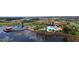 Stunning aerial view of the community clubhouse, pool, and lake with pier at 541 Arena Dr, Davenport, FL 33837