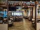 Spacious bar area with wood floors, flat-screen TVs, tables, chairs, and plenty of natural light at 541 Arena Dr, Davenport, FL 33837